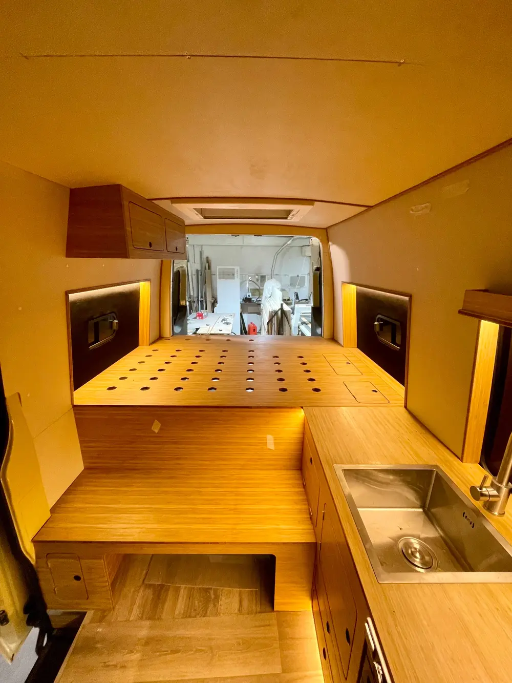 Bamboo campervan interior with CNC machined bed base and kitchen worktop