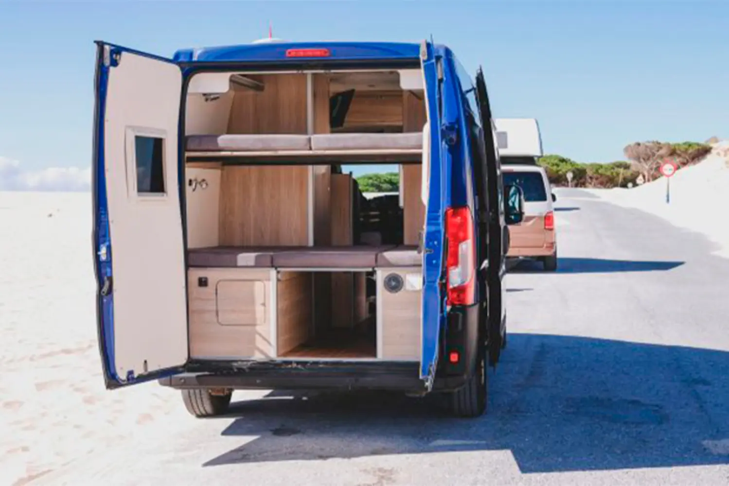 Van conversion with CNC cut wooden camper furniture and bed system